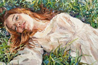 Obraz Na Płótnie .A Red-Haired Beauty, A Young Girl Lies And Dreams On The Field Among Various Summer Grasses And Wildflowers. O